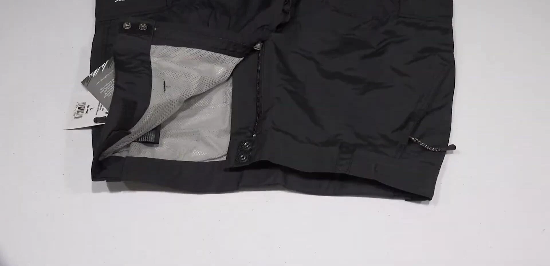 Detail shot showing the waist adjustment features and zippered cuffs.