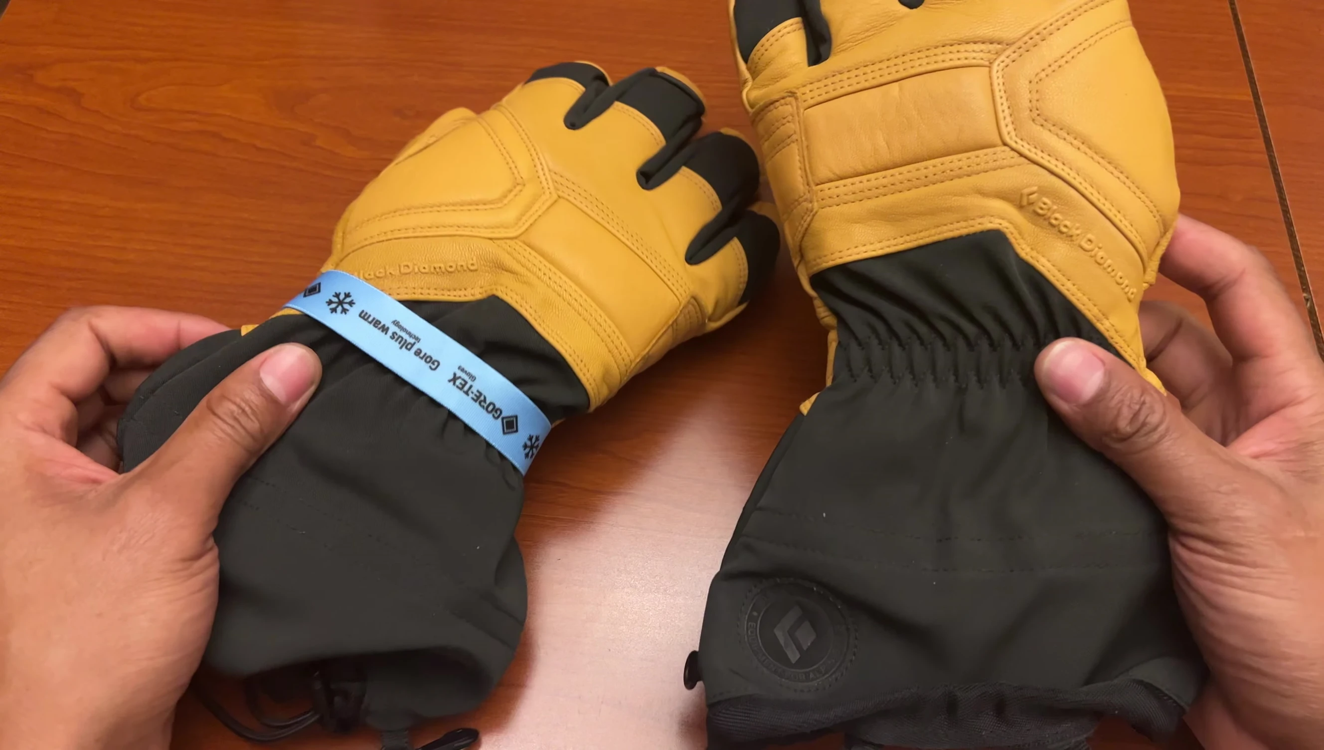 The reviewer holding the gloves, showcasing their fit.