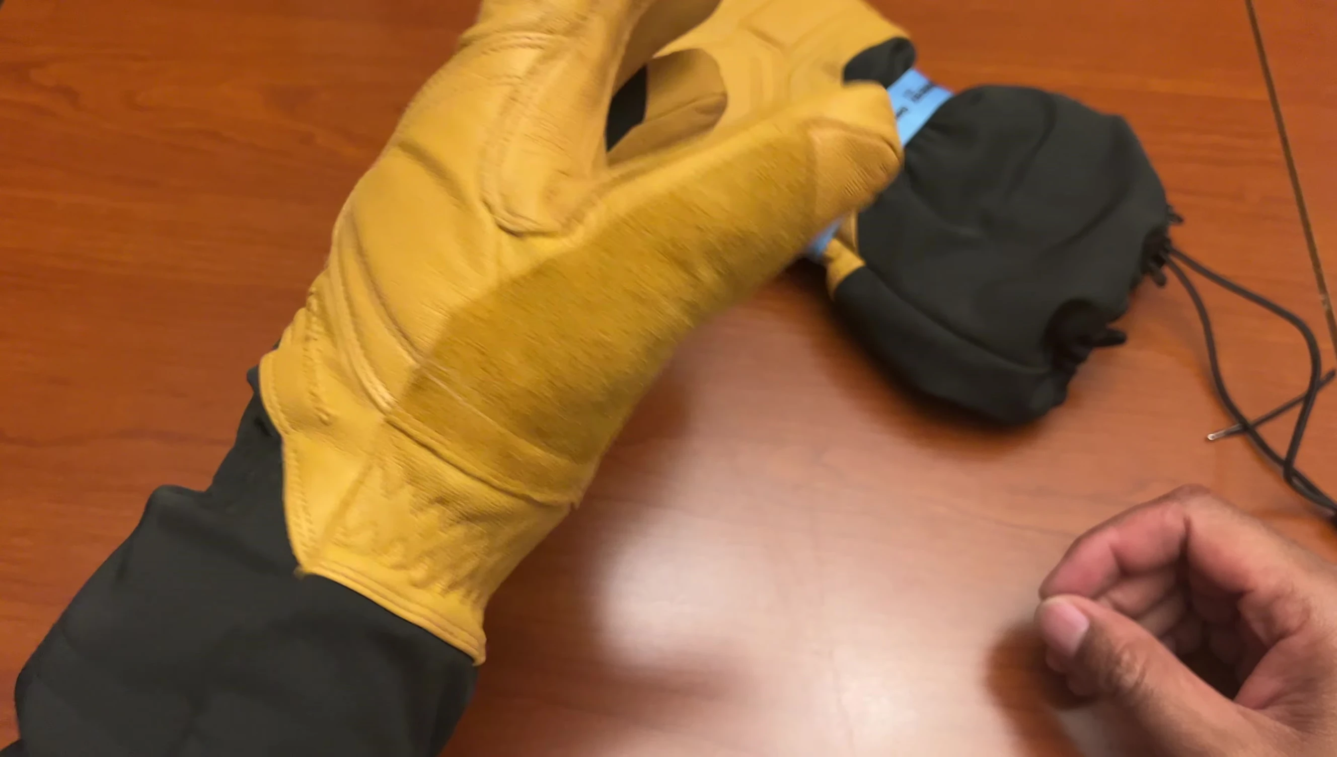 The reviewer wearing the gloves, demonstrating their flexibility and fit.