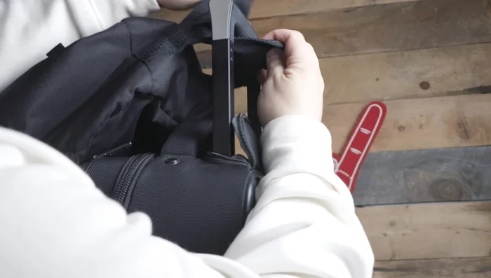 Explaining how to attach the bag to another rolling bag for hands-free transport.