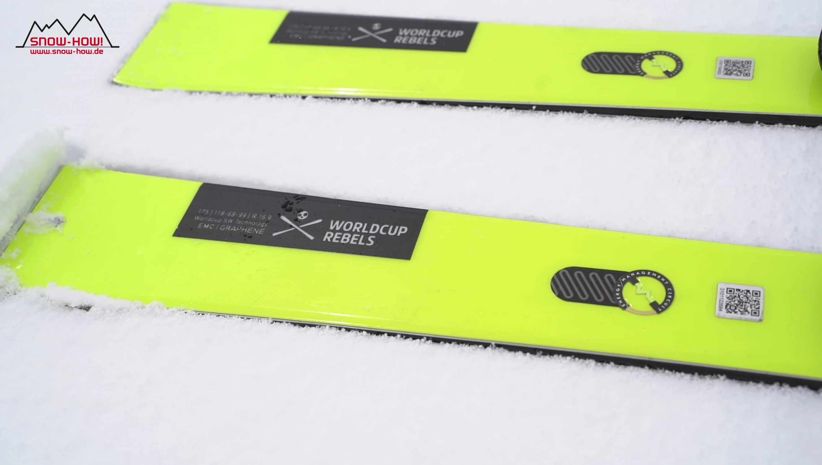 The Head Worldcup Rebels e-Race Pro skis displayed against a snowy mountain backdrop.