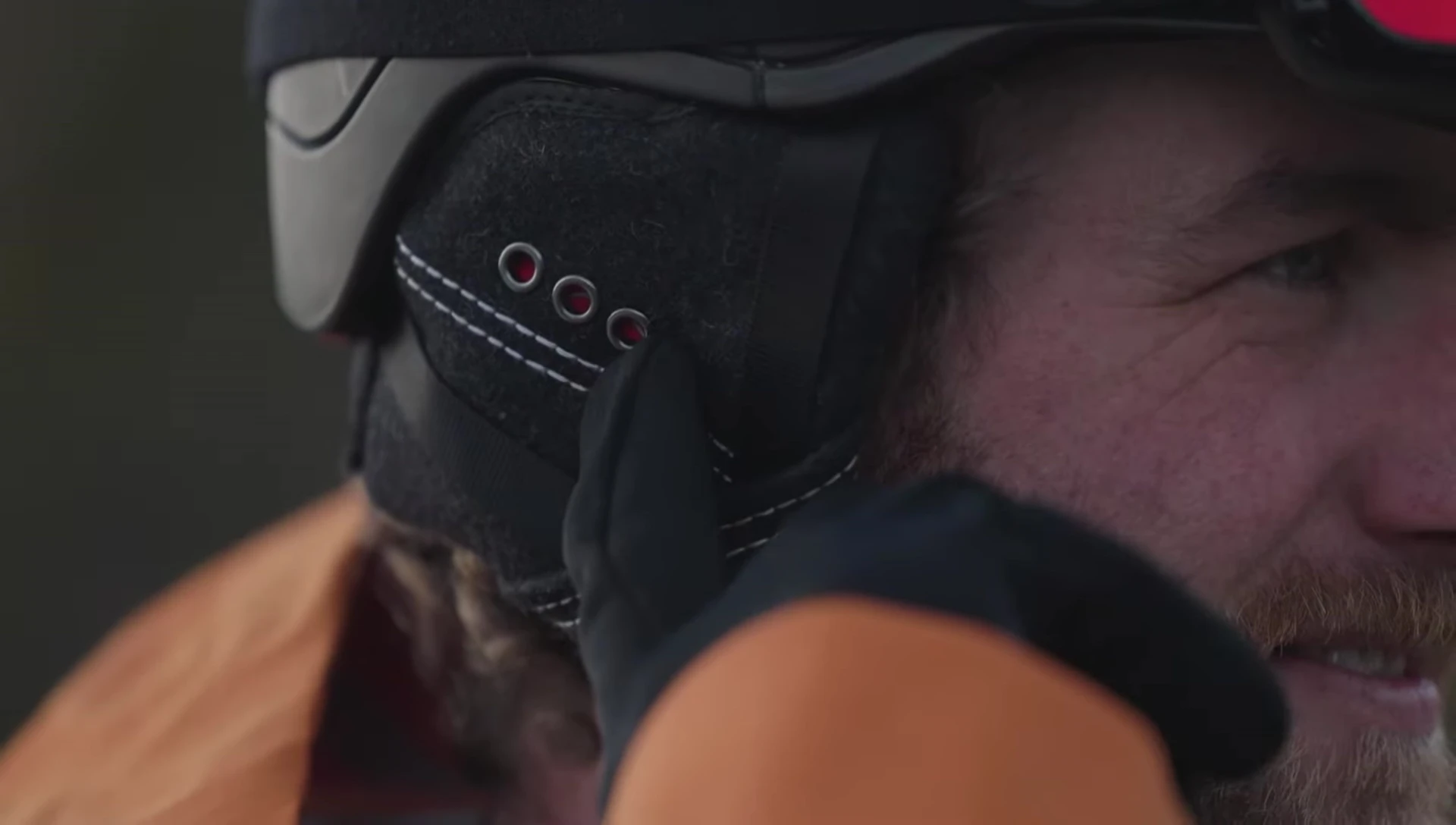 The Chips 3.0 helmet speakers with lights blinking, indicating power on.