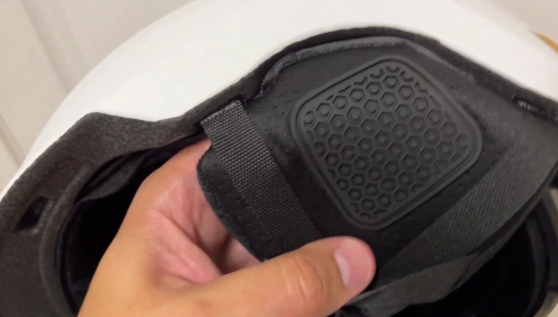 The reviewer pointing to the ear covers.