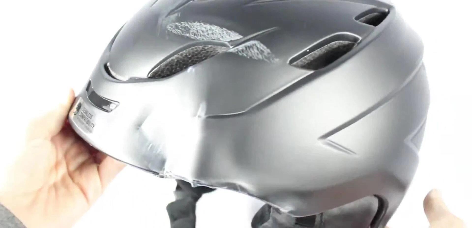 Close-up shot of a helmet's outer shell being inspected