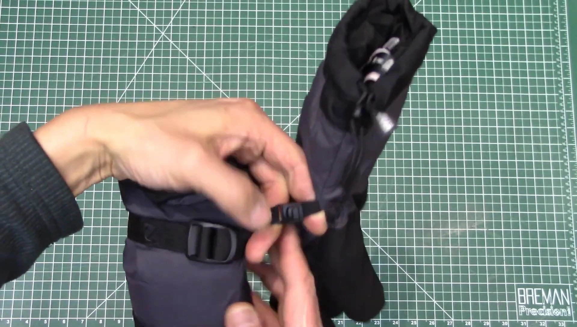 Close-up showcasing the clasp connecting the two gloves