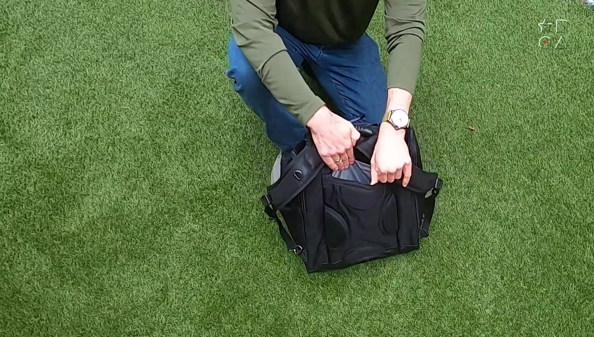 Close-up of the back pocket and its function for storing backpack straps.