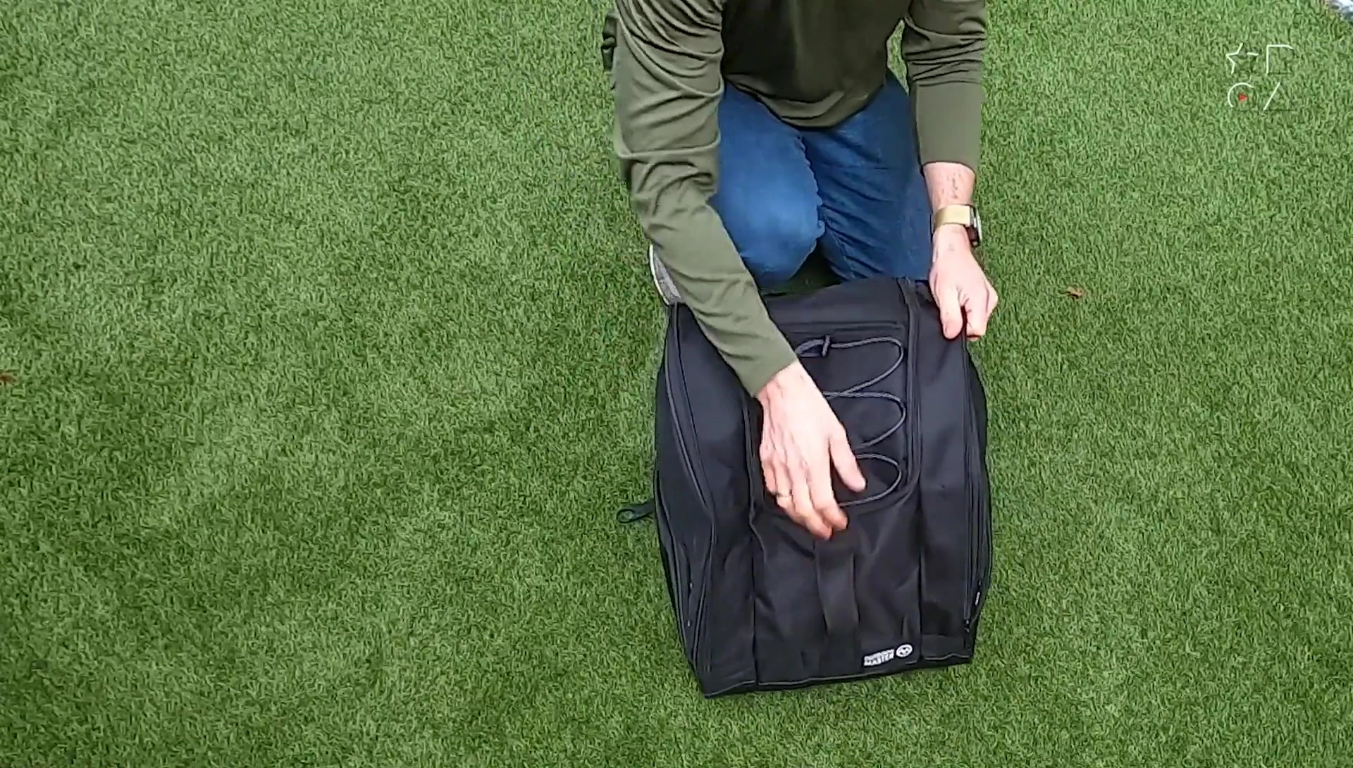 Showing the large top handle and the small front mesh pocket.